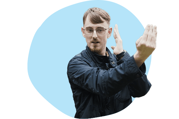 A young man communicating in BSL.