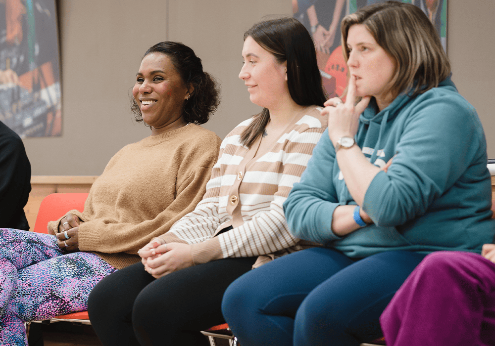 Three teachers sat together in a CPD session.